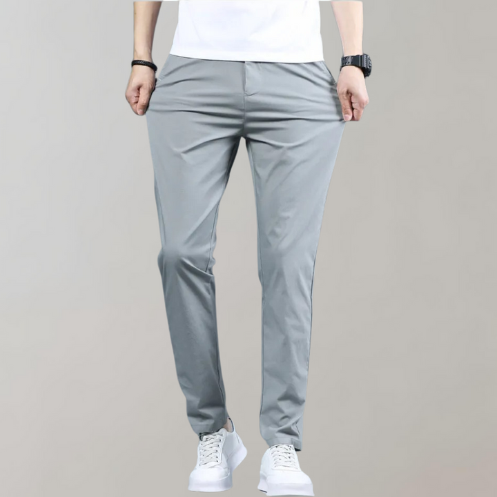 Close-up of the hem of men's slim-fit casual pants, indicating a clean and tailored finish.