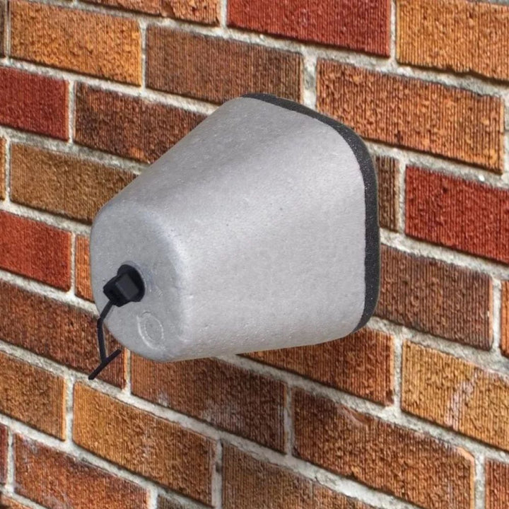 "Gray polystyrene outdoor spigot protector with Velcro strap, providing winter insulation cover for faucets against freeze da
