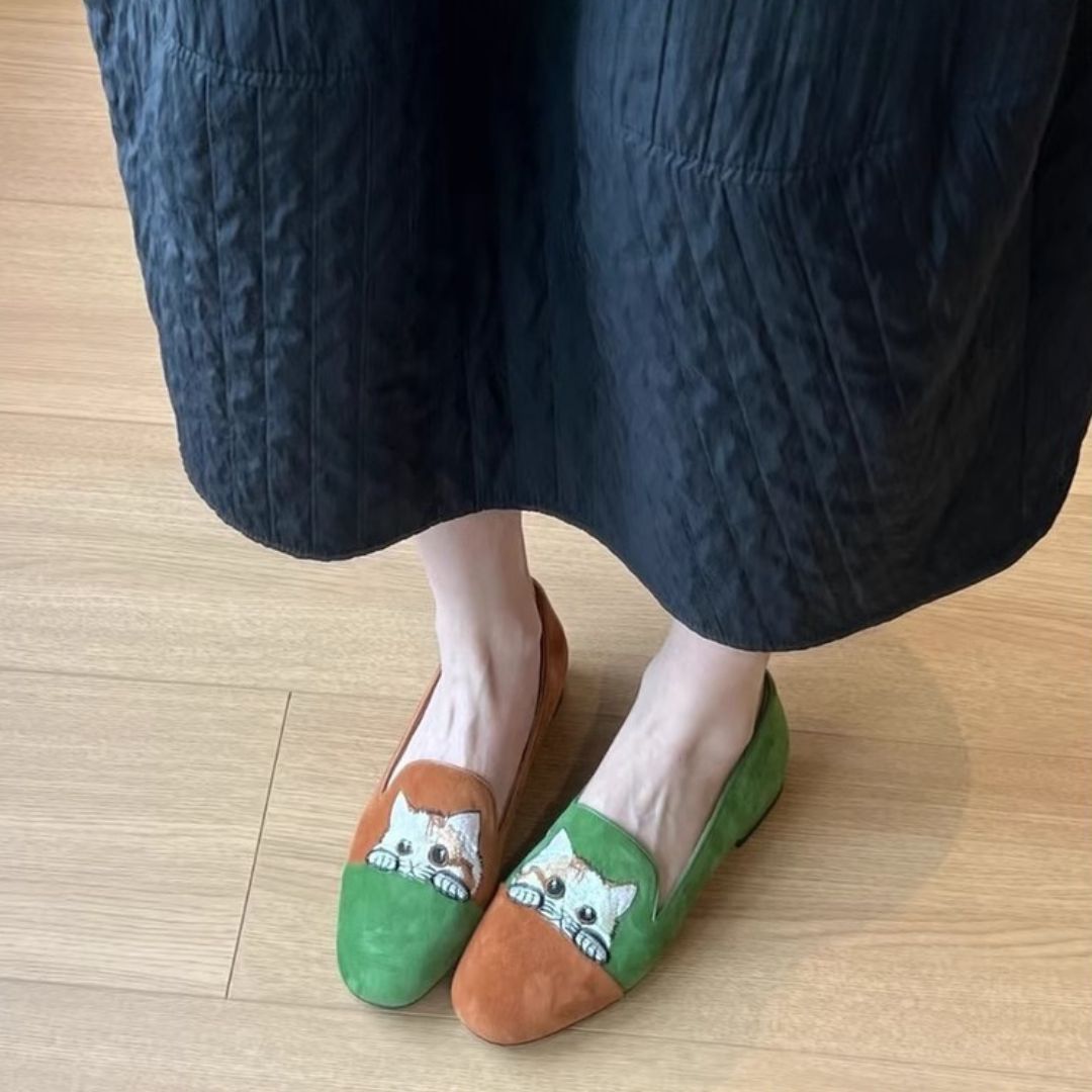 Pair of women's embroidered cat suede loafers in green and tan, perfect for a casual look