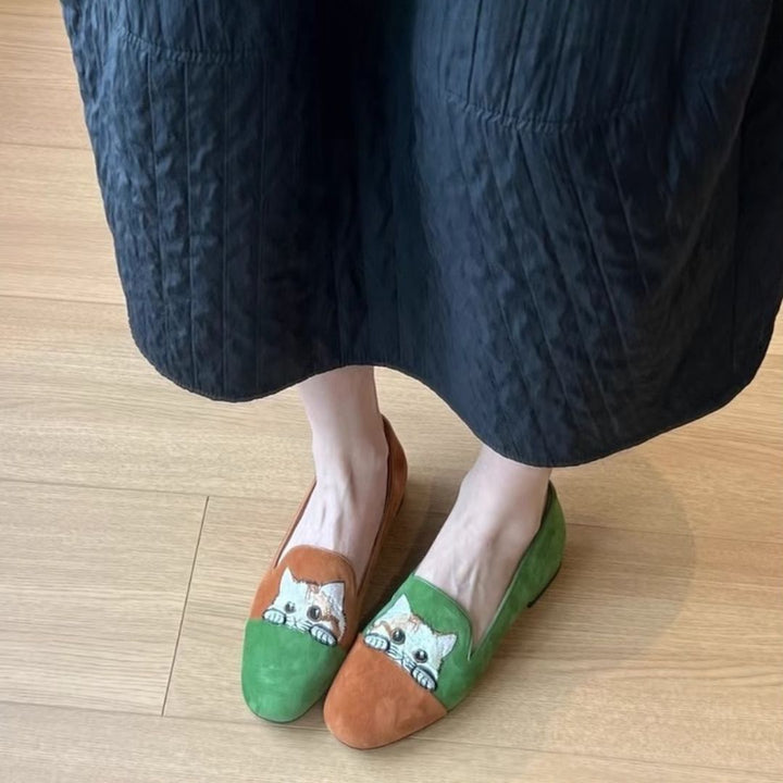 Pair of women's embroidered cat suede loafers in green and tan, perfect for a casual look