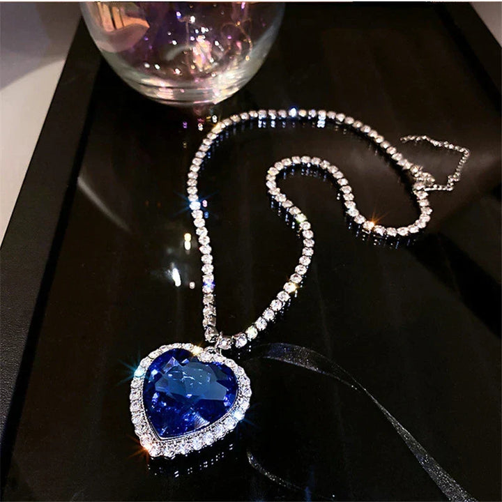 Elegant women's sterling silver heart necklace with sparkling blue zirconia, perfect gift.