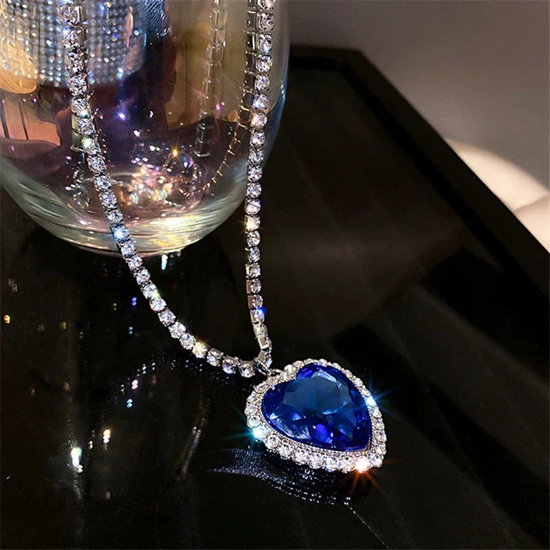 Fashionable women's heart pendant, sterling silver, adorned with vibrant blue zirconia stones.