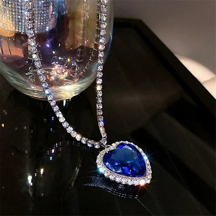 Fashionable women's heart pendant, sterling silver, adorned with vibrant blue zirconia stones.