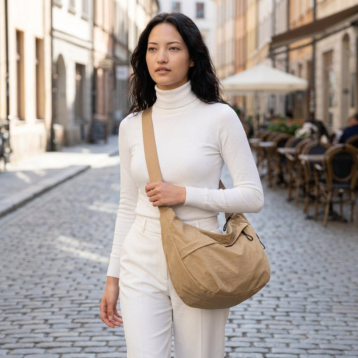 Organized women's nylon crescent sling bag with multiple pockets, ideal for travel & daily use.