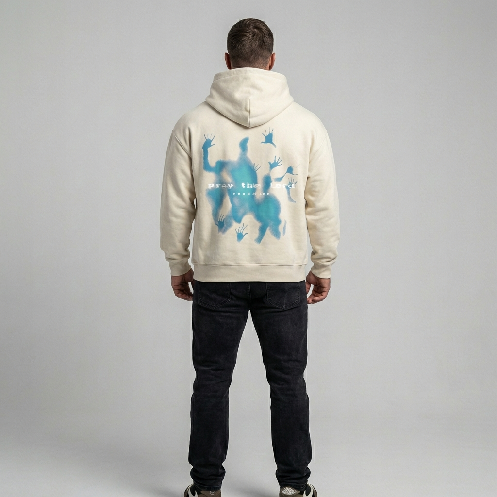 Model wearing a relaxed fit beige graphic oversized hoodie. Unisex streetwear fashion pullover for a casual, comfortable look.