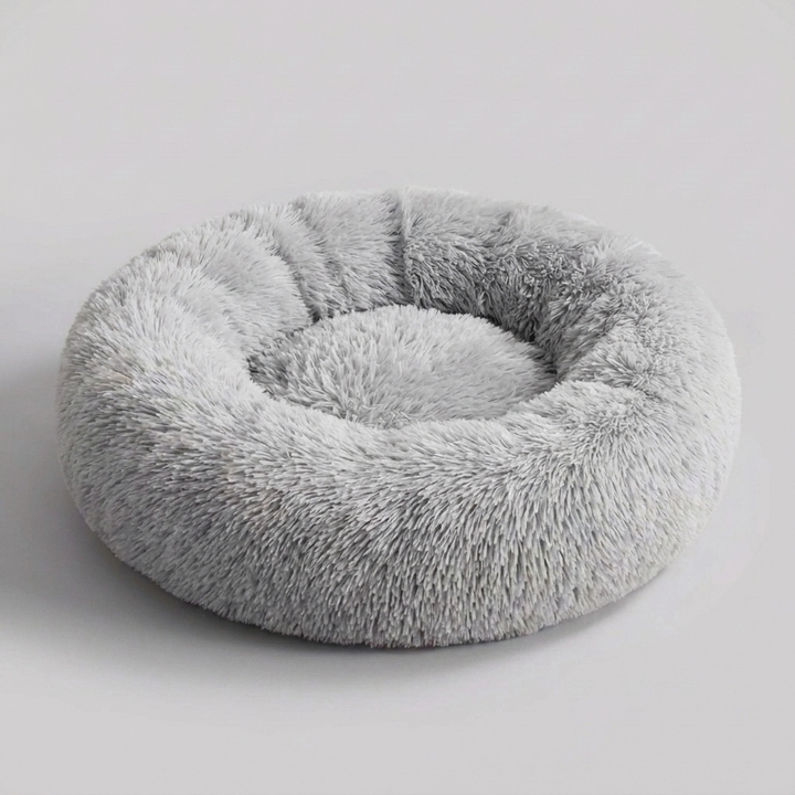 Large calming pet bed for anxious dogs, cozy faux fur, provides anxiety relief & comfortable rest.