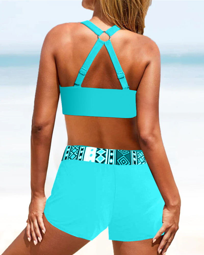 Women's high-waisted geometric print bikini on model, showing beach-ready style & comfortable, flattering fit.