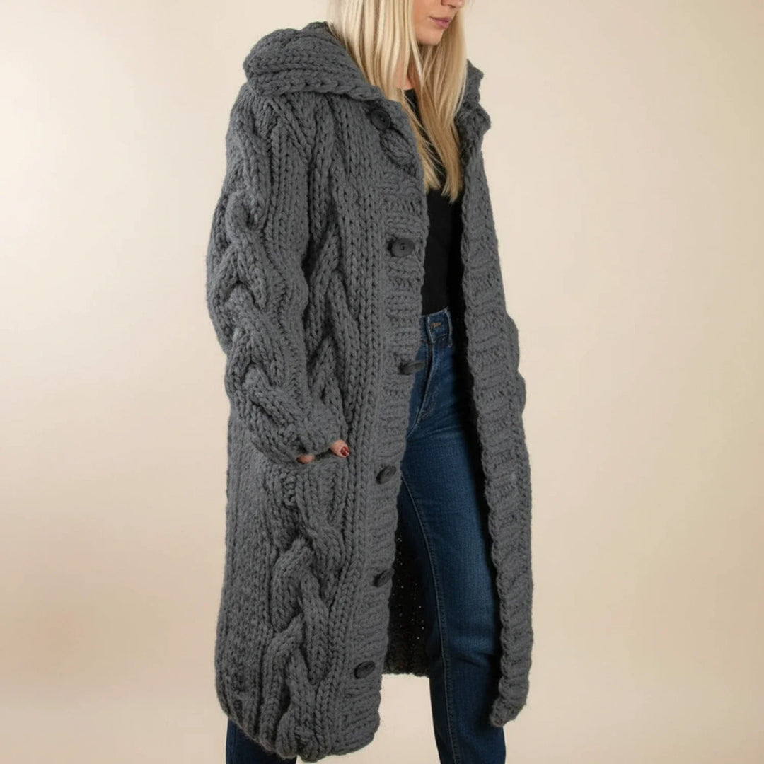 Cozy hooded long cardigan for women, a warm winter layer. Features comfortable knit and functional button-front closure.