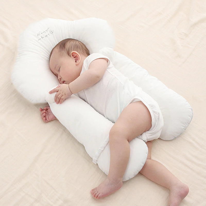 Infant U-shape organic cotton head support pillow for gentle sleep, newborn comfort in stroller or car seat.