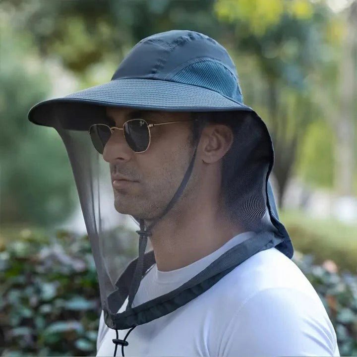 Person wearing a unisex wide brim outdoor hat, offering sun protection, insect shield, and neck flap for trail comfort.