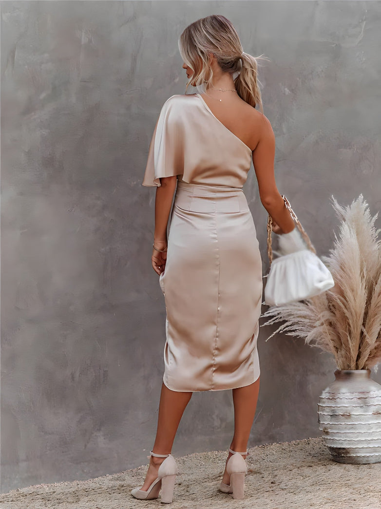 Close-up: elegant fabric and off-shoulder detail on a women's asymmetrical party midi dress.