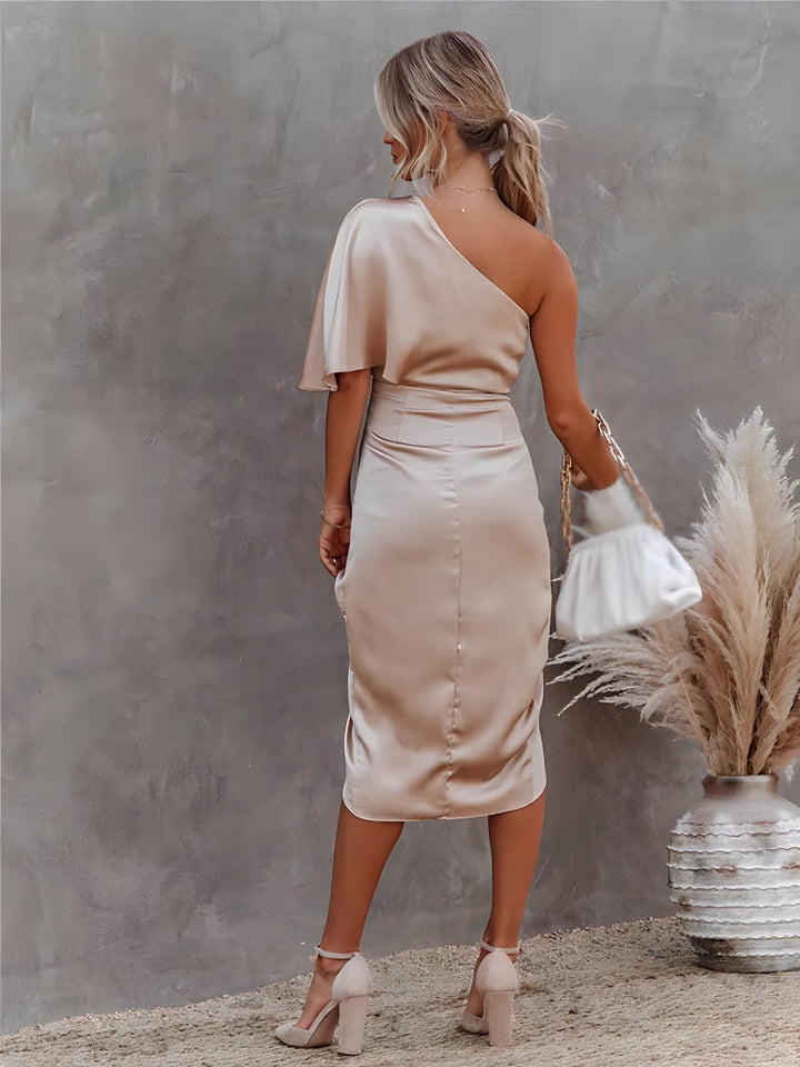 Close-up: elegant fabric and off-shoulder detail on a women's asymmetrical party midi dress.