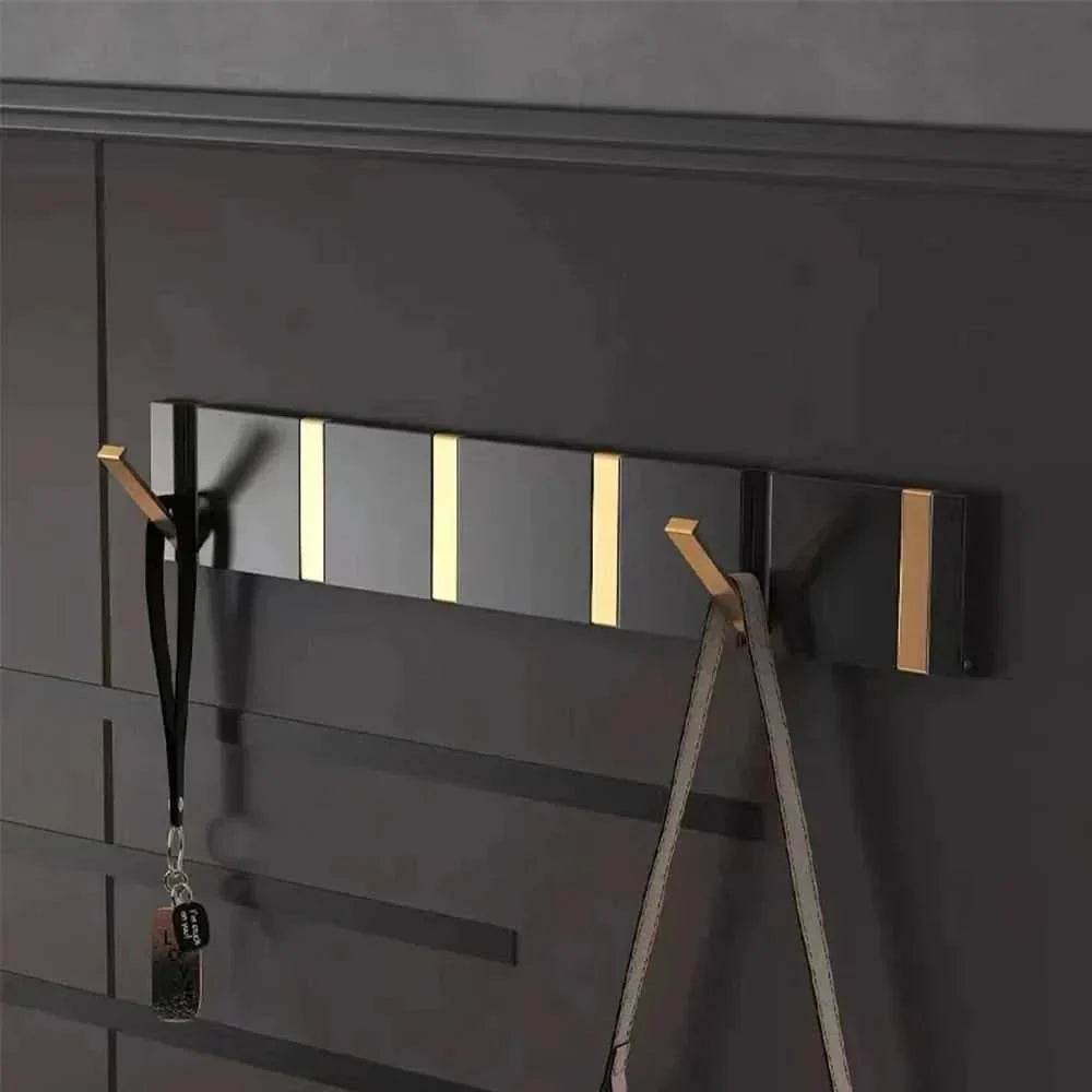 Folding aluminum wall hook for smart, space-saving home organization.