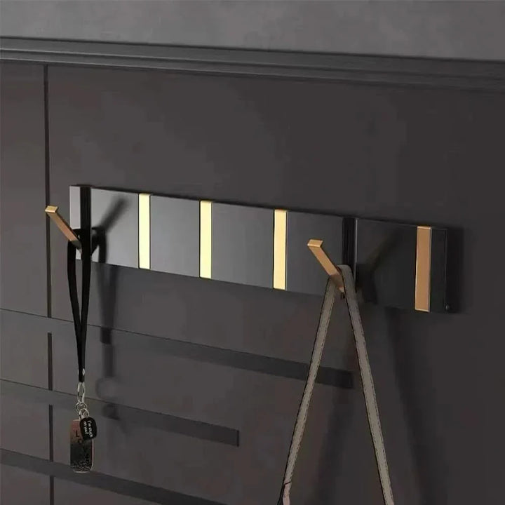 Folding aluminum wall hook for smart, space-saving home organization.