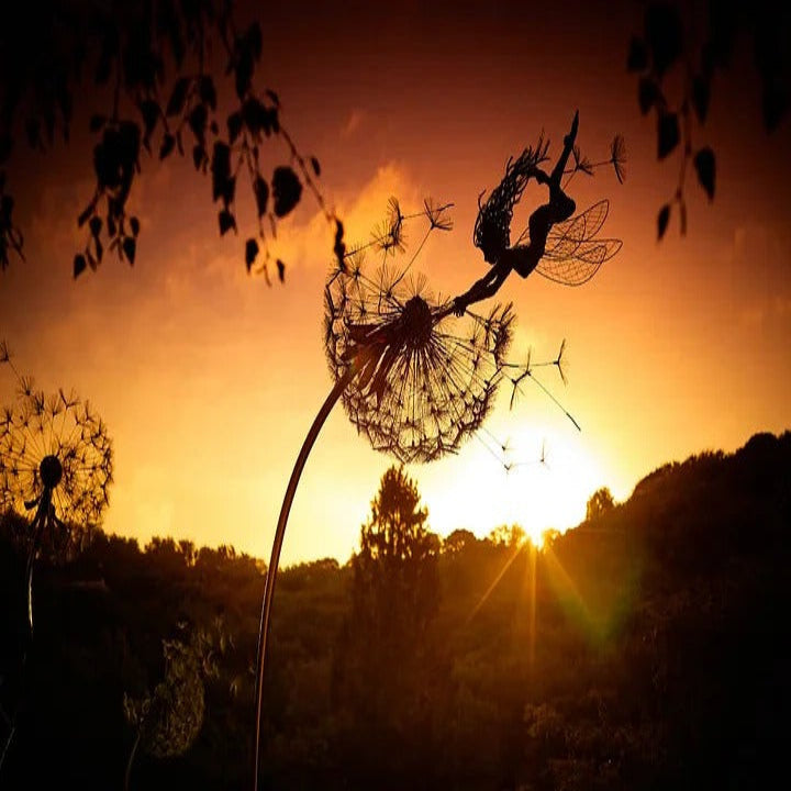 Outdoor metal art garden stake featuring a whimsical fairy and dandelion motif for home exterior decor.