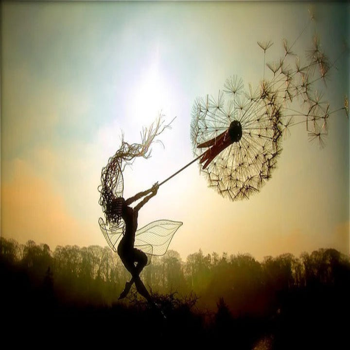 Decorative metal fairy & dandelion garden stake, ideal for whimsical outdoor yard art and patio accents.