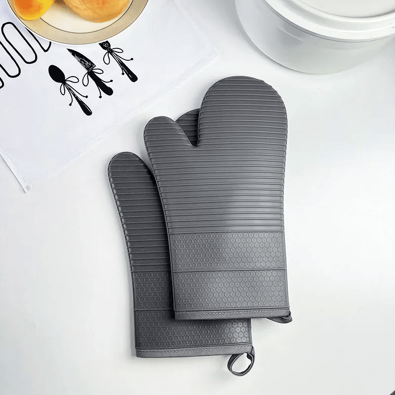 Unisex heat resistant silicone gloves, essential kitchen tools for safe handling of hot items.