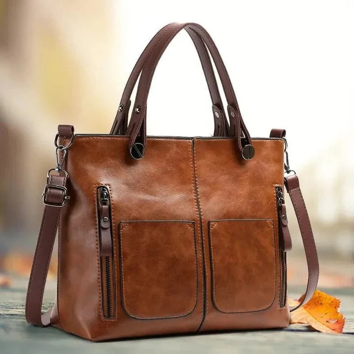 Classic women's leather shoulder bag with a sleek minimalist design, ideal as a stylish work or travel tote.