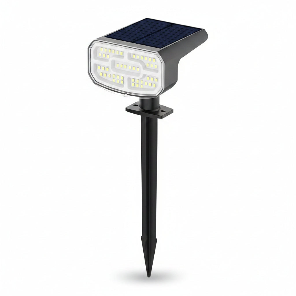 Waterproof LED solar spotlights (4-pack) with cool white light for pathways, walls & backyard decor.