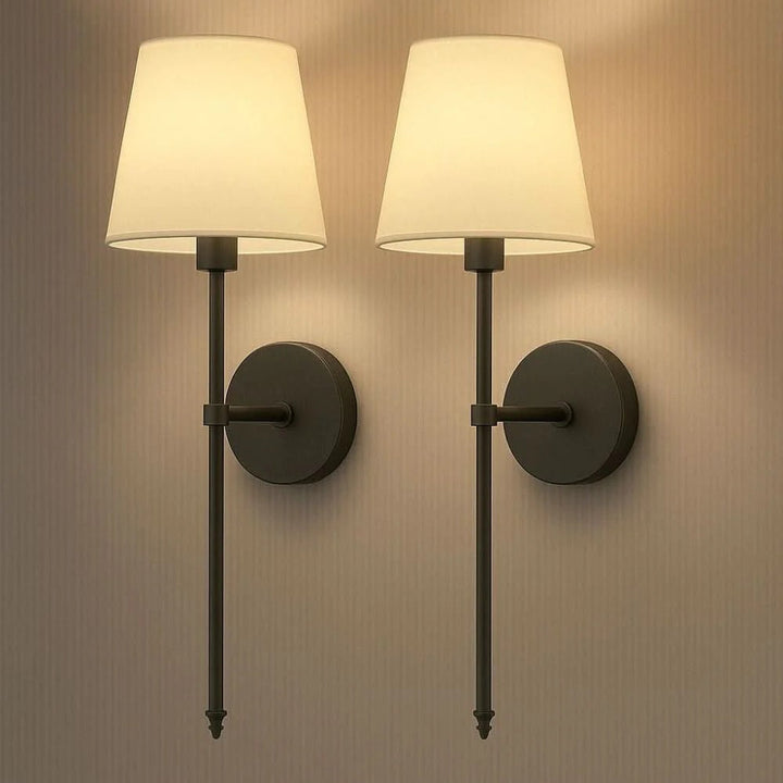 Detail of the remote control adjusting the light on a sleek, battery operated wall sconce, highlighting wireless use.