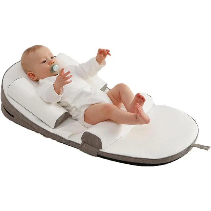 Cozy infant side sleeper pillow for newborn comfort. Secure support helps baby sleep soundly & peacefully.