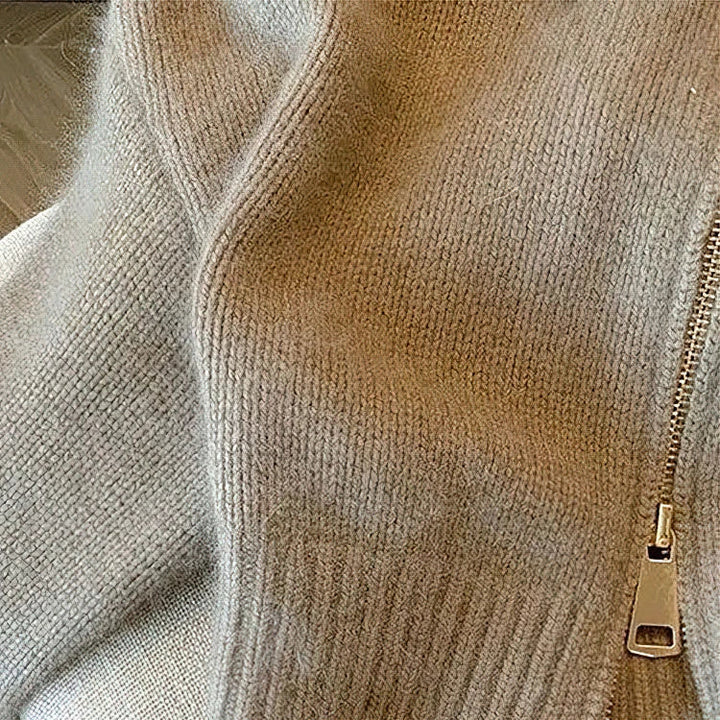 Flat lay of a women's khaki cable knit cardigan, featuring a practical zip front