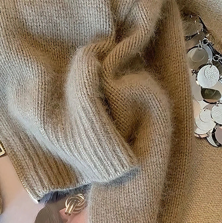 Detail of the zip front on a cozy khaki long-sleeve cable knit women's cardigan