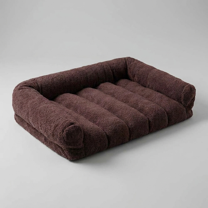 Soft fleece orthopedic cat bed with bolster and headrest, offering cozy joint support for your pet's comfort.