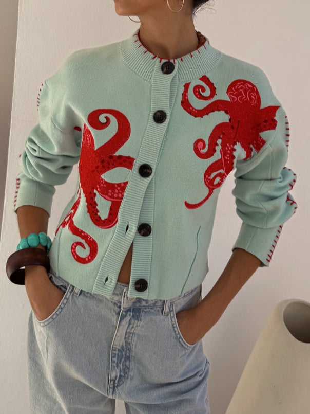 Light blue women's knit cardigan with unique octopus pattern and button front. Comfortable fashion sweater.