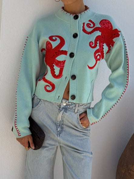 Women's fashion knit cardigan with a vibrant blue octopus pattern. Long-sleeve, button-front, casual style.