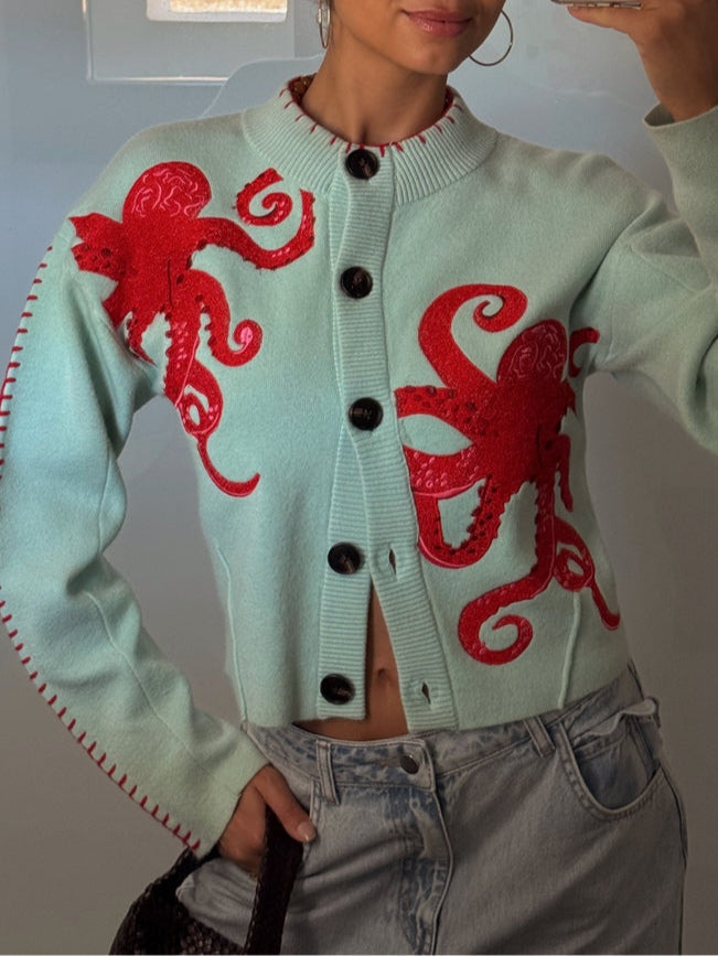 Eye-catching light blue women's knit cardigan. Unique octopus pattern, long sleeves, and button-front design.