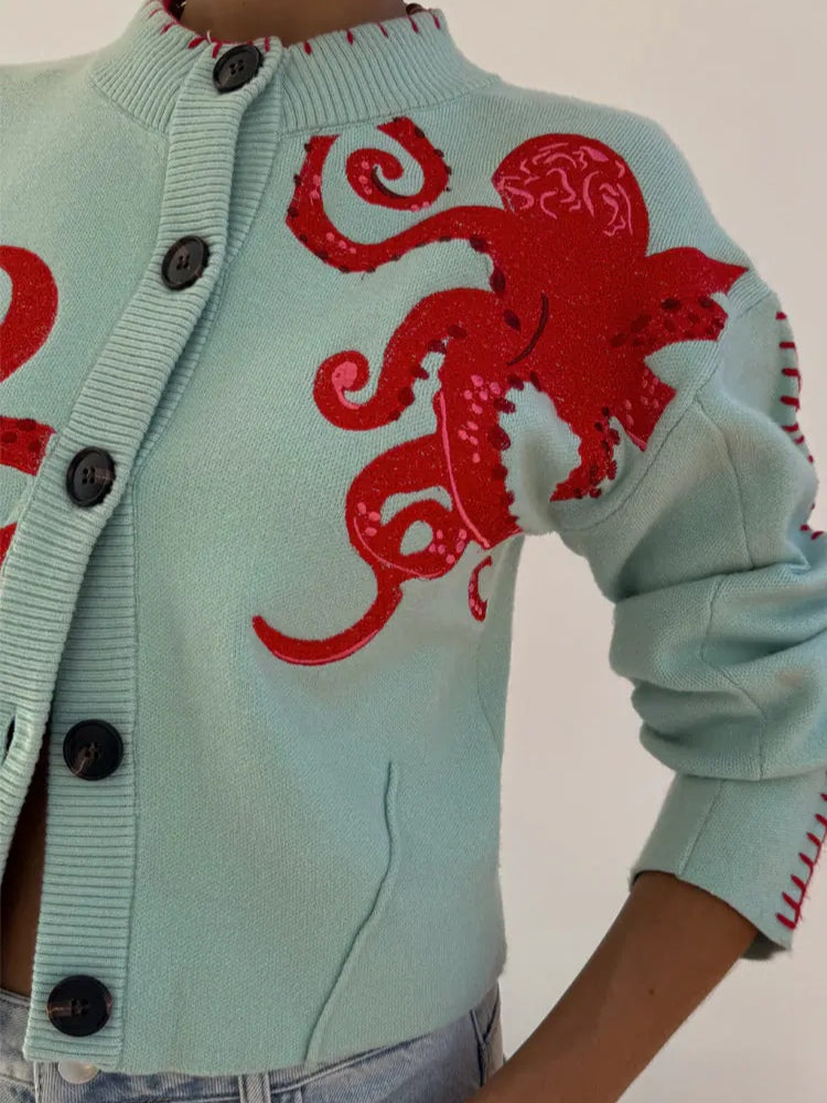 Women's light blue knit cardigan, a stylish layering piece. Features unique octopus pattern & button front.