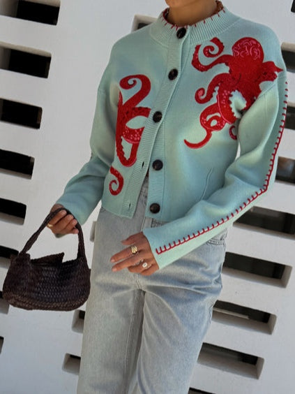 Light blue women's long-sleeve knit cardigan with unique octopus pattern. Button-front closure, comfortable.