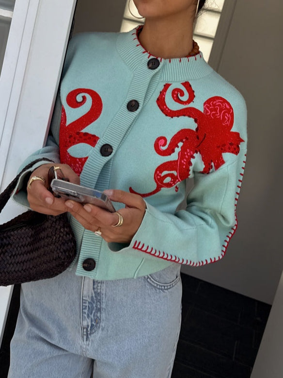 Fashionable women's light blue knit cardigan. Distinctive octopus pattern, long sleeves, and button-front closure.