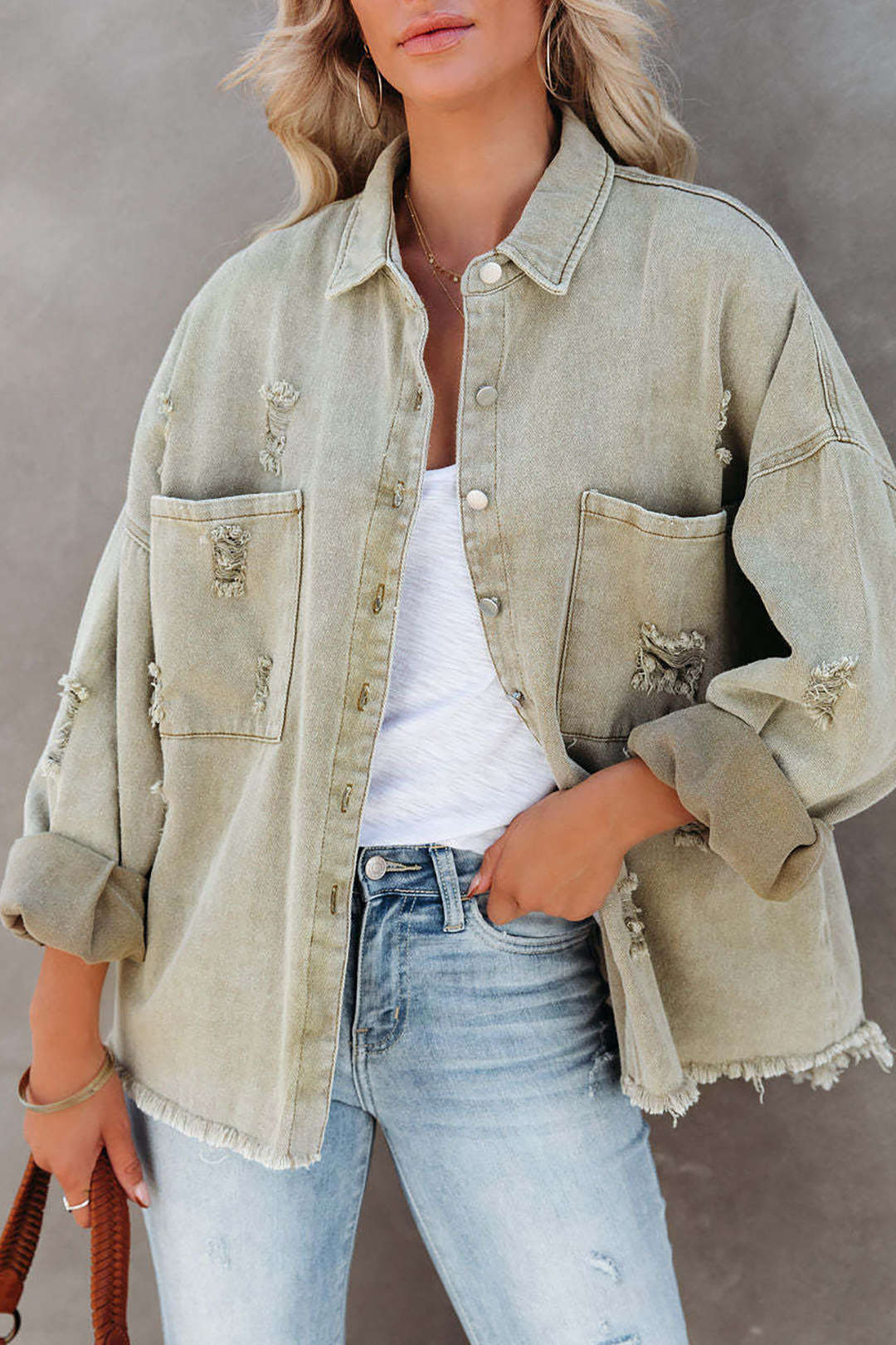 Light green distressed denim jacket for women, oversized & stylish for casual summer fashion.