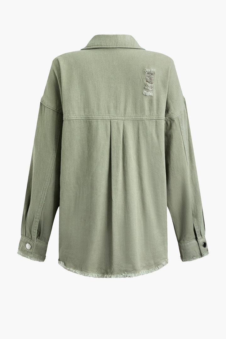 Close-up of a women's light green distressed denim jacket, showcasing unique rips and an oversized fit.