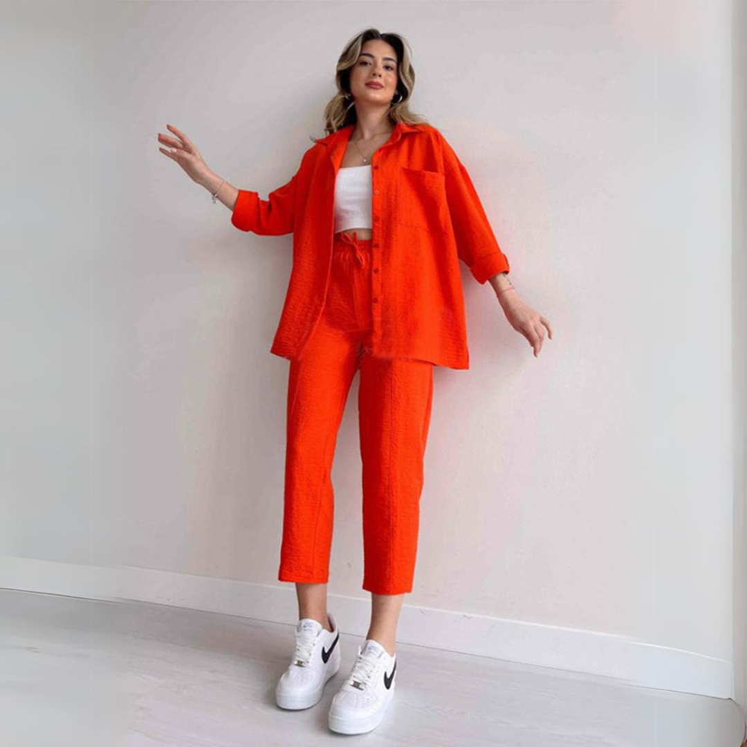 Elegant women's summer two-piece linen set with a relaxed blouse and wide-leg trousers for chic seasonal comfort.