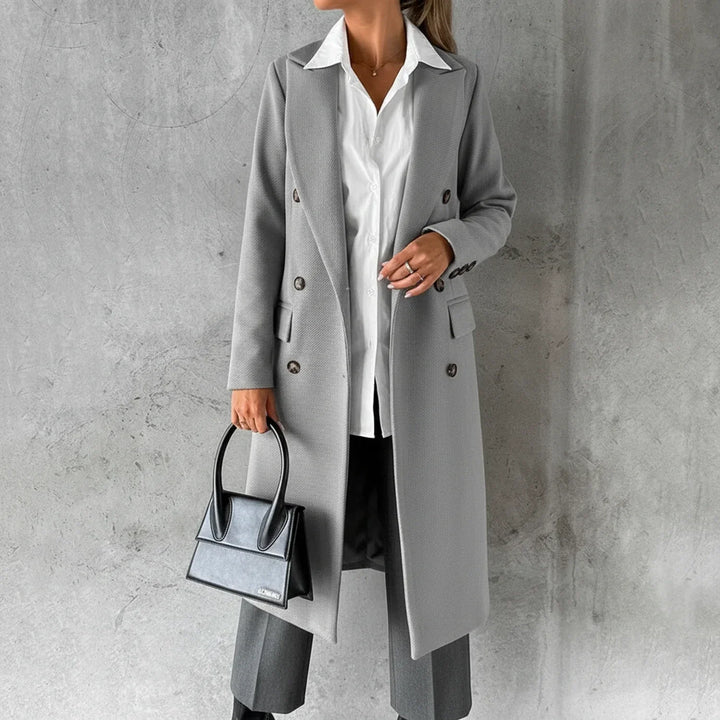 Warm knee-length women's winter coat, double-breasted design for chic and cozy fall outerwear.