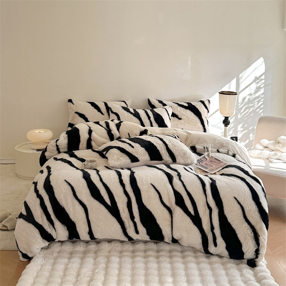 Plush zebra print fluffy faux fur bed sheet set. Experience luxury, warmth, and cozy animal print style in your bedroom.