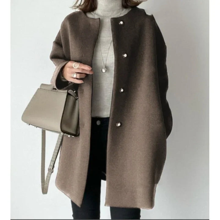 Stylish women's oversized minimalist button coat. A versatile long fall/winter layering piece for an elegant look.