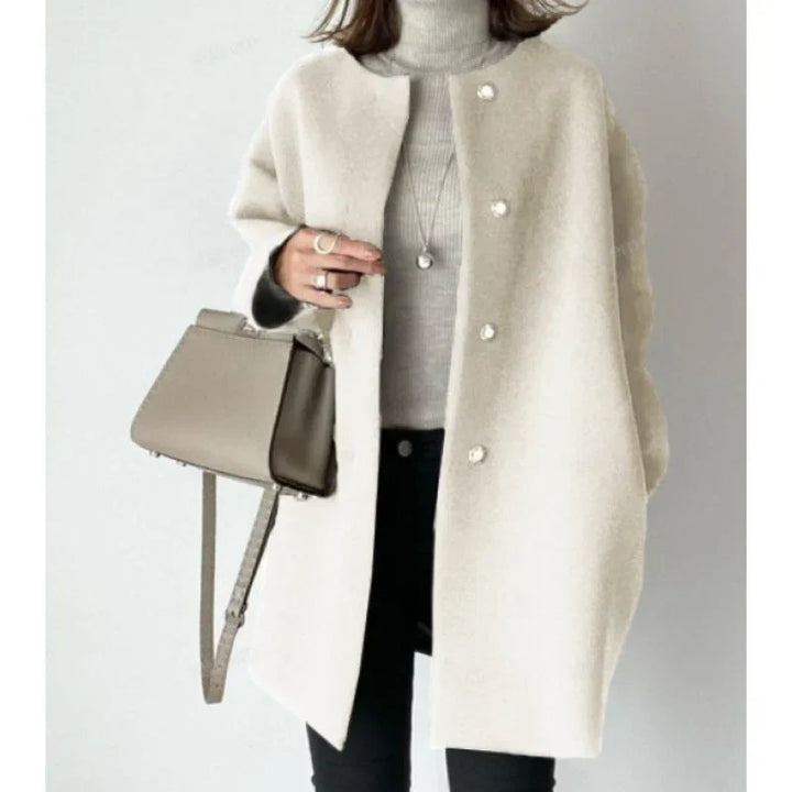 Women's minimalist oversized long button coat. Chic and versatile outerwear for sophisticated fall and winter outfits.