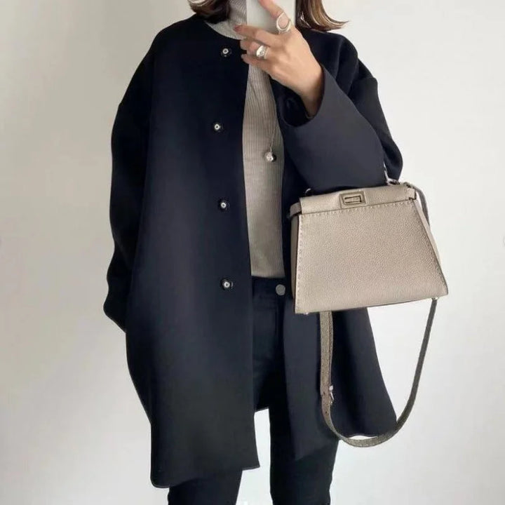 Elegant oversized button-front long coat for women. Minimalist design, ideal for chic office or casual winter fashion.