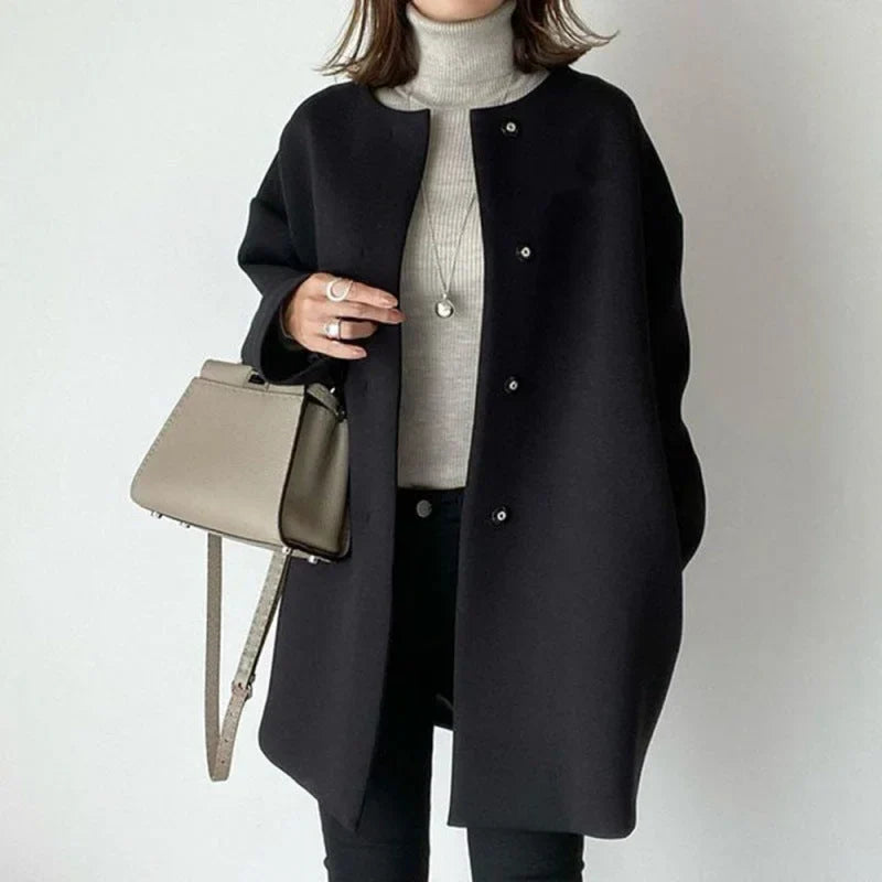 Chic women's minimalist oversized button coat, perfect for fall & winter layering. Elegant long outerwear.