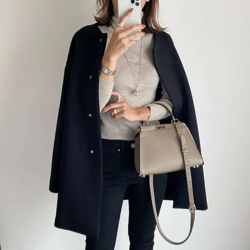 Long women's oversized button coat with a minimalist design. Chic outerwear for elegant fall/winter fashion & layering.