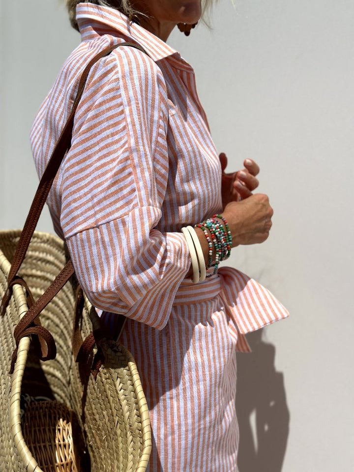 Chic women's striped button-front shirt midi dress with a relaxed fit, perfect for warm weather style.