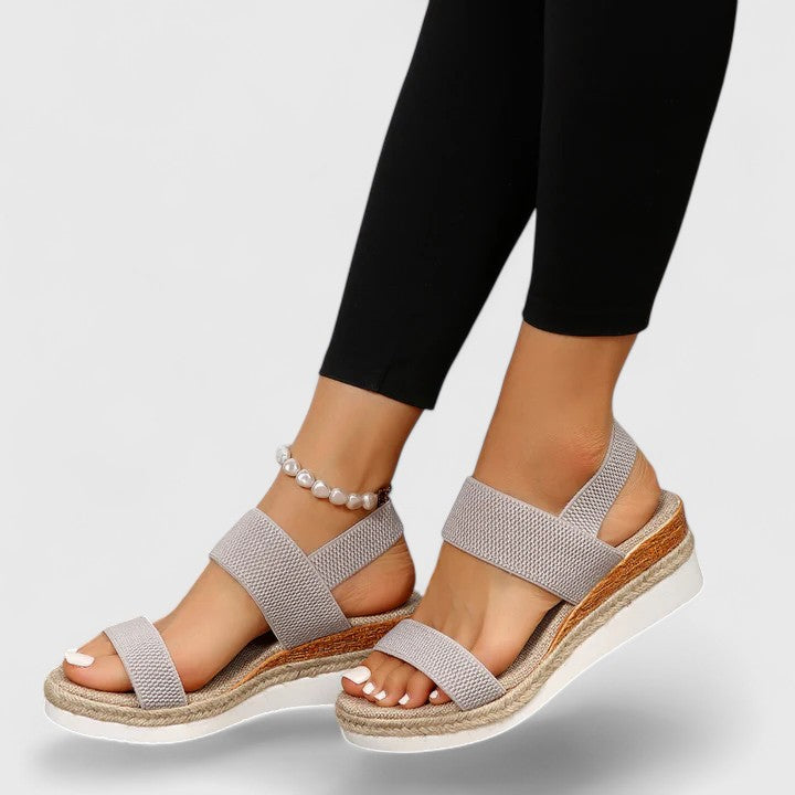 Women's orthopedic wedge sandals paired with a summer dress, perfect casual and comfortable outfit.