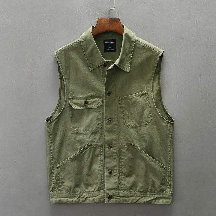 Dark brown men's utility vest, cotton workwear-inspired, featuring multiple pockets, rugged fashion