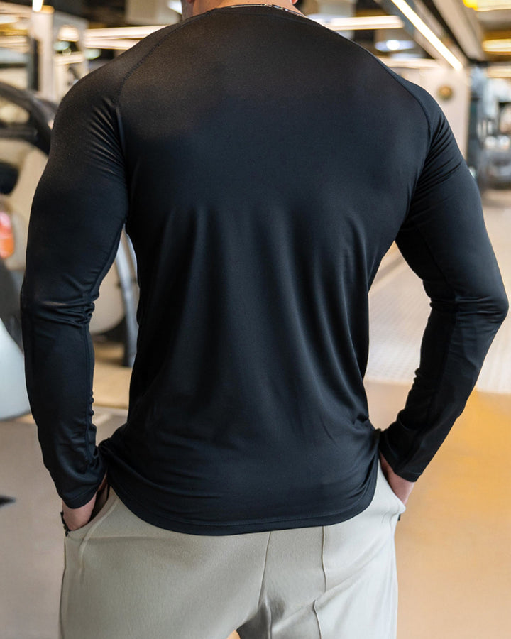 Close-up of moisture-wicking fabric on men's athletic long sleeve shirt, shoulder cut design