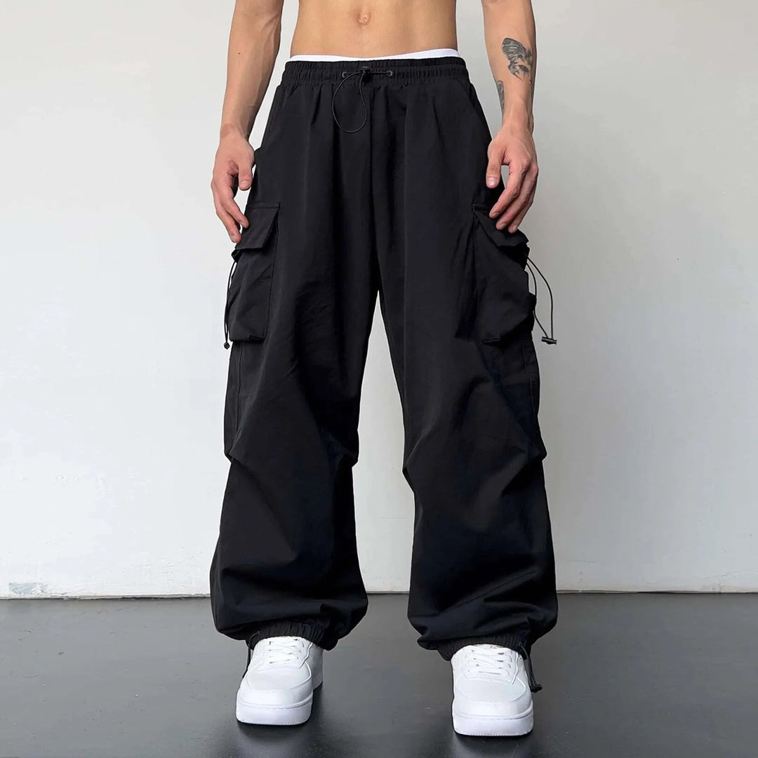 Men's Y2K fashion baggy cargo parachute pants with utility pockets. Comfortable loose fit for casual streetwear.