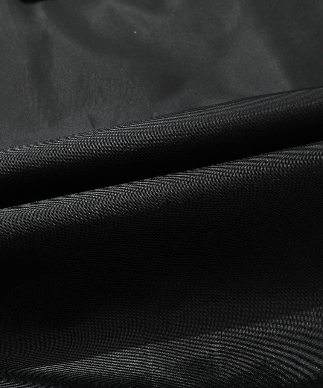 Full-length view of men's bomber jacket, brown PU leather, with zipped pockets, detachable hood.